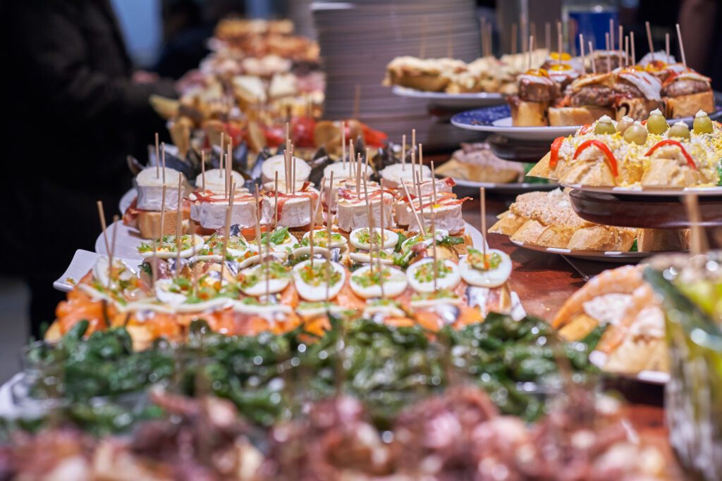 Must eat in San Sebastian Spain, pintxos lined across a bar